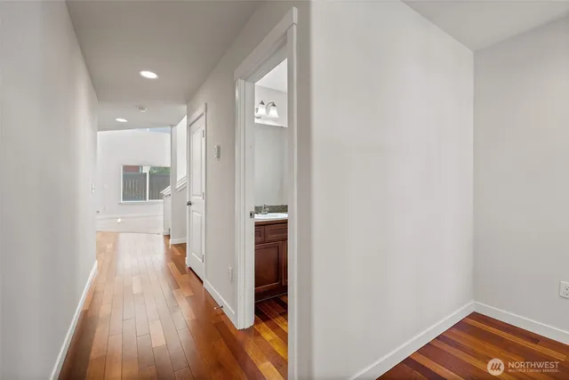 a view of a hallway with wooden floor