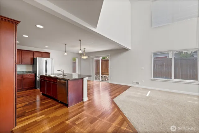 a large kitchen with stainless steel appliances kitchen island granite countertop a large counter top and oven