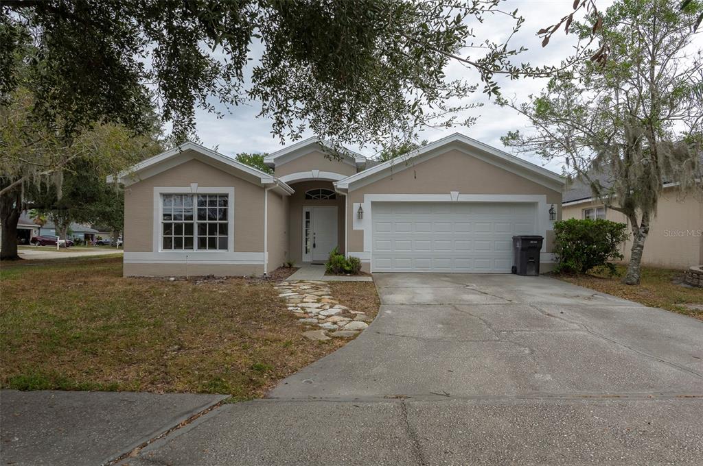 15017 Shaw Road Tampa, FL 33625 - Photo 1 of 1 a front view of a house with a garden