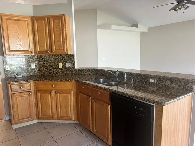 a kitchen with stainless steel appliances granite countertop a sink and a cabinets