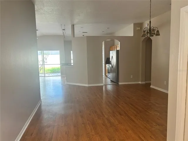 a view of a room with wooden floor and a window
