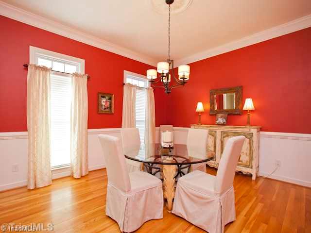 7839 Wilson Farm Road Summerfield, NC 27358 - Photo 4 of 16 Dining Room. Spacious Dining room with beautiful hardwood floors, beautiful moldings and chair rail trim.