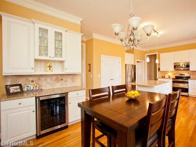 7839 Wilson Farm Road Summerfield, NC 27358 - Photo 6 of 16 Kitchen. Spacious kitchen with serving area, and wine cooler.