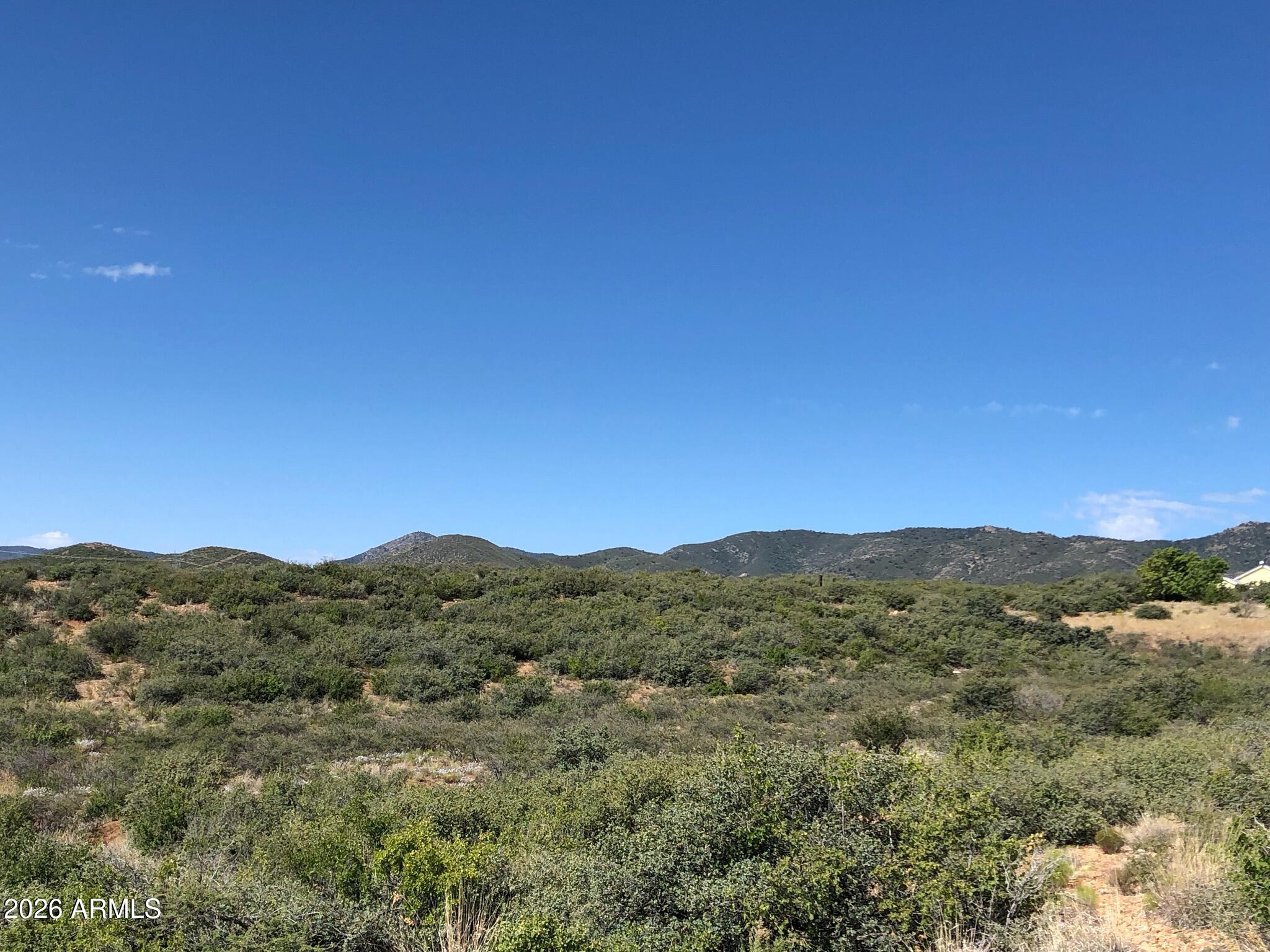 10424 East Prescott Dells Road, Unit 21 Dewey, AZ 86327 - Photo 6 of 6 a view of a mountain range with trees in the background