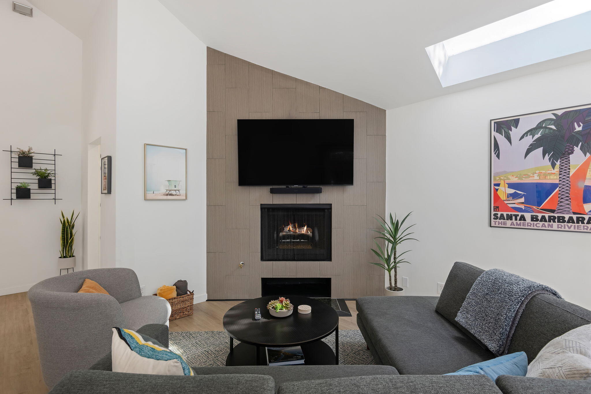a living room with furniture a fireplace and a flat screen tv