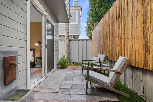 a backyard of a house with outdoor seating