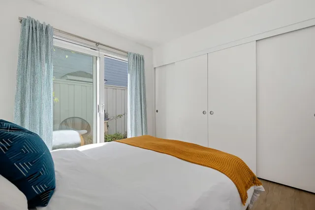 a bedroom with a bed and a mirror