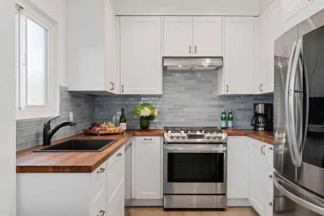 a kitchen with a sink a stove and refrigerator