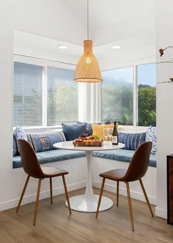 a dining room with furniture and wooden floor
