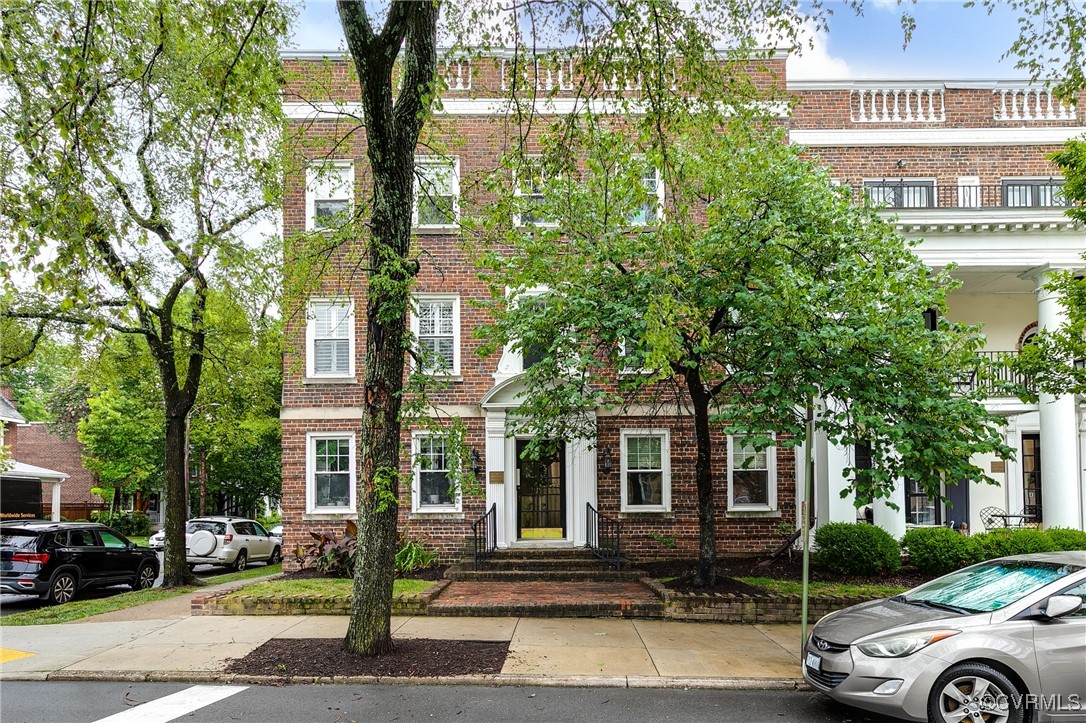 a front view of a building with trees