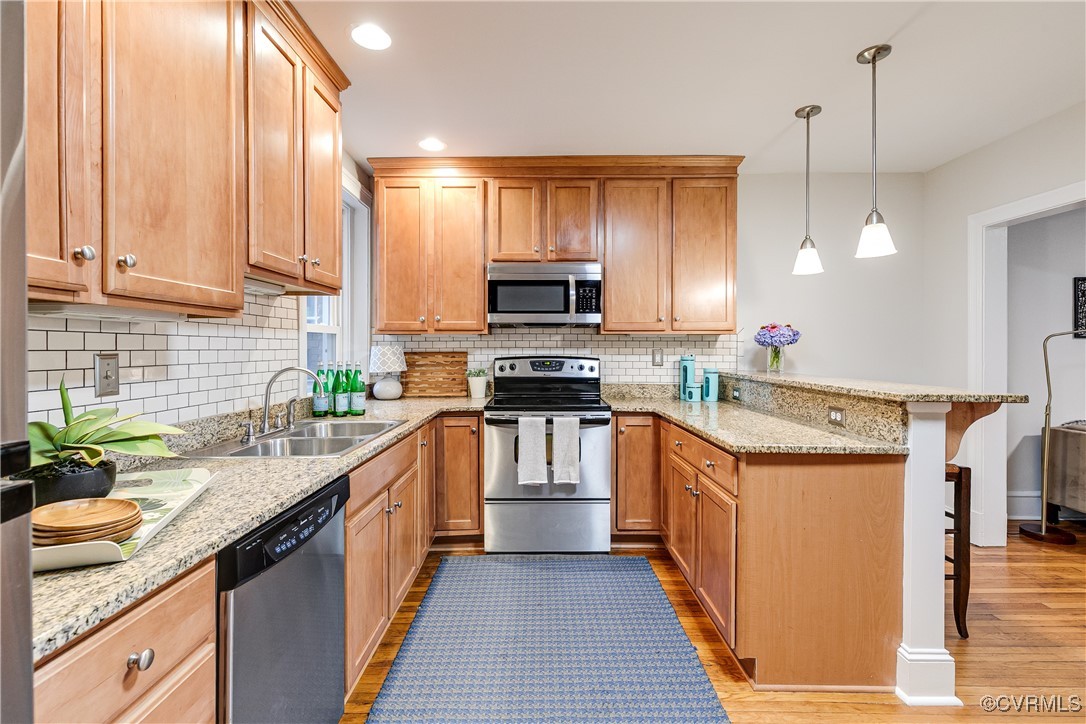 619 Roseneath Road, Unit U21 Richmond, VA 23221 - Photo 11 of 21 a kitchen with stainless steel appliances granite countertop a stove a sink and a microwave