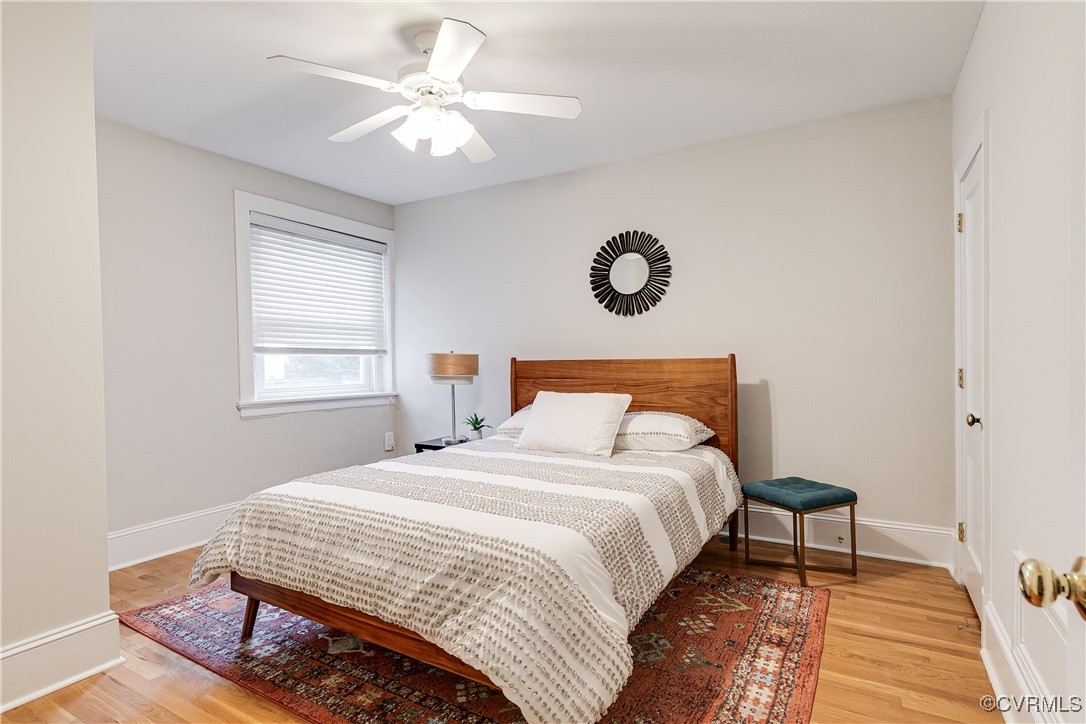 619 Roseneath Road, Unit U21 Richmond, VA 23221 - Photo 15 of 21 a bedroom with a bed and a chandelier