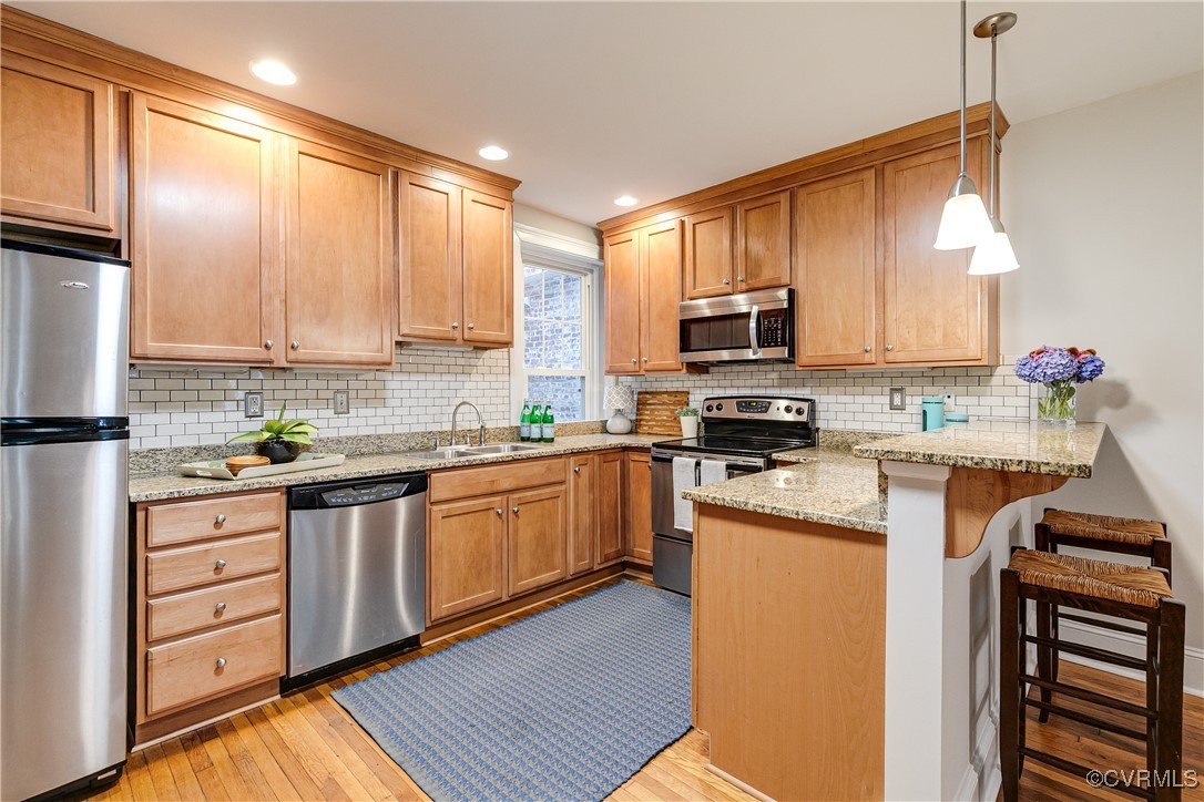 619 Roseneath Road, Unit U21 Richmond, VA 23221 - Photo 10 of 21 a kitchen with stainless steel appliances granite countertop a stove top oven a sink dishwasher a refrigerator and cabinets with wooden floor