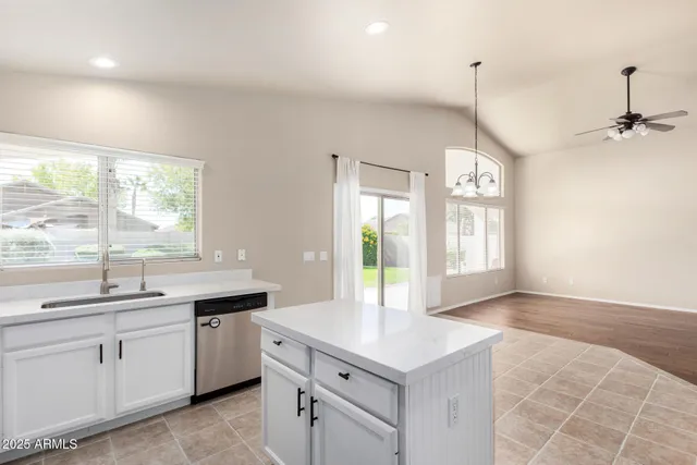 a kitchen with a sink a window and cabinets