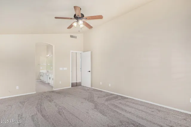 a view of a room with a ceiling fan