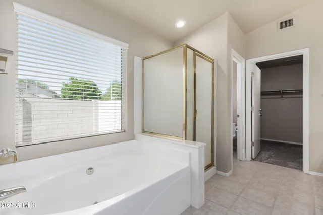 a bathroom with a bathtub and a shower