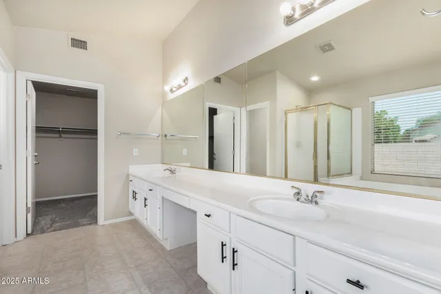 a spacious bathroom with a double vanity sink mirror and double