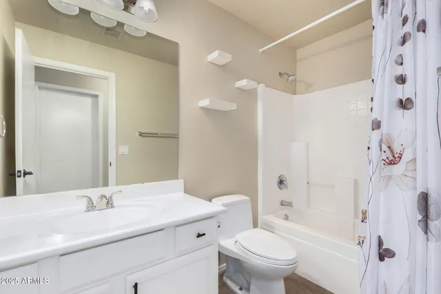 a bathroom with a granite countertop sink toilet a shower and a mirror