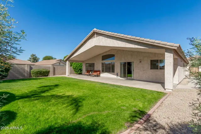 a view of a house with a backyard