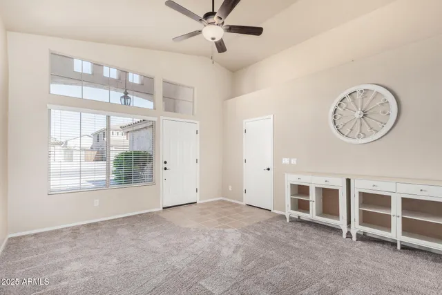 an empty room with a cabinet and a large window