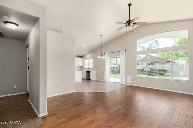 a view of a livingroom with a ceiling fan and window