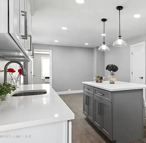 a kitchen with a sink and chandelier