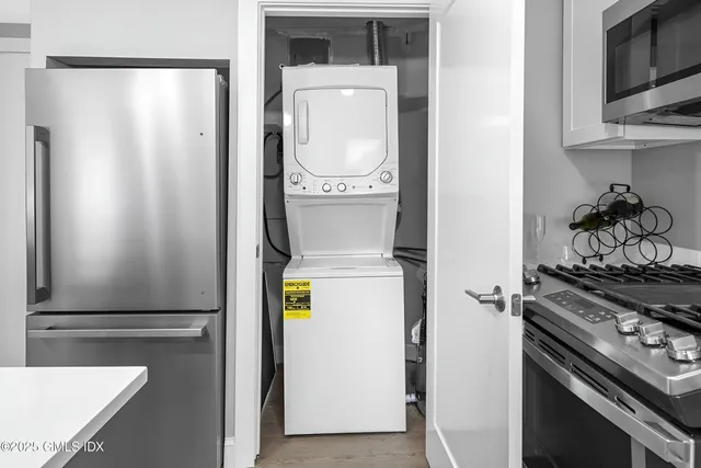 a bathroom with a granite countertop sink and a washing machine