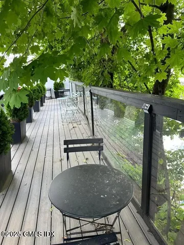 a view of balcony with wooden floor and outdoor seating
