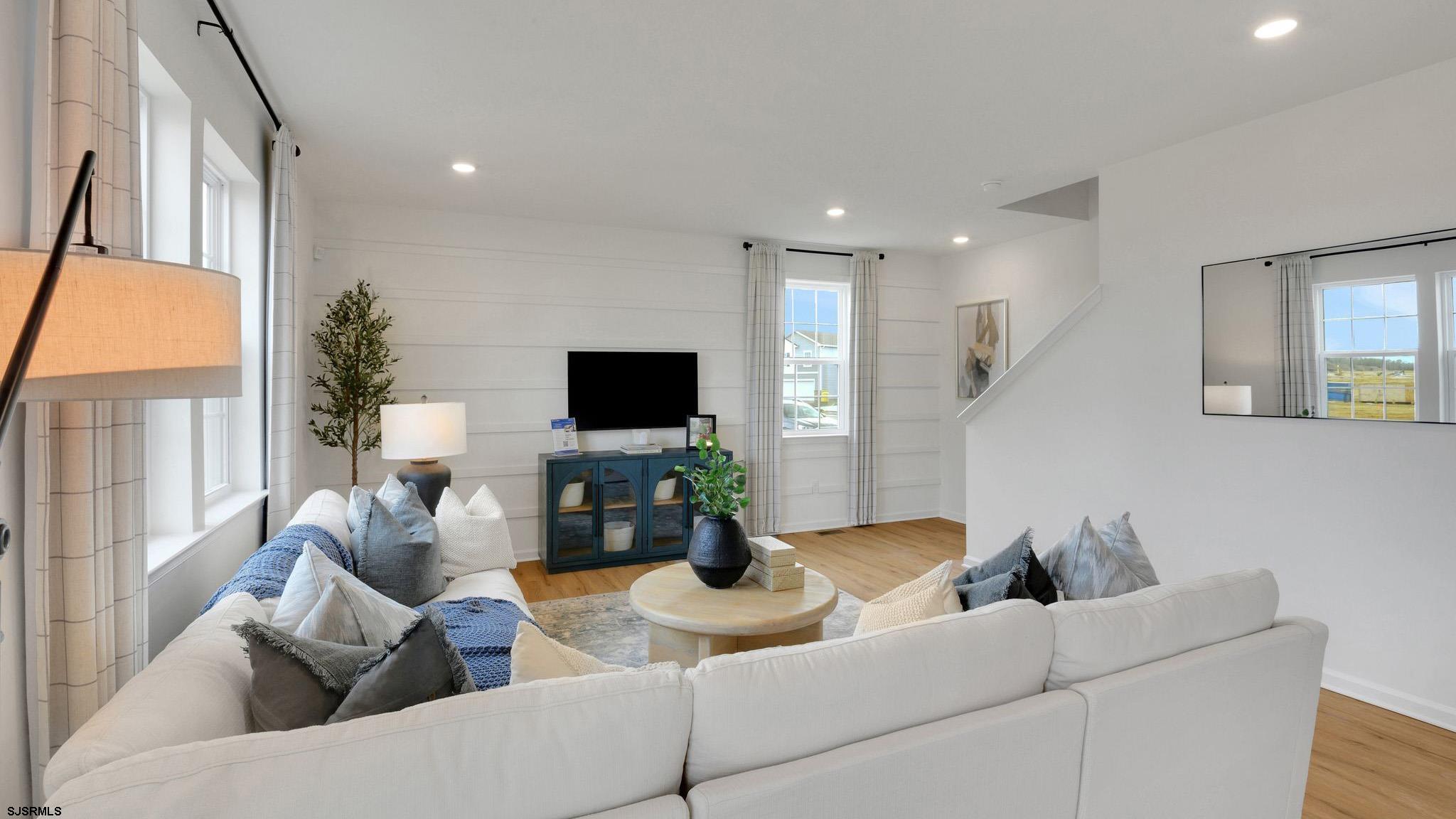 223 Daytona Road Egg Harbor Township, NJ 08234 - Photo 12 of 31 a living room with furniture a flat screen tv and a large window
