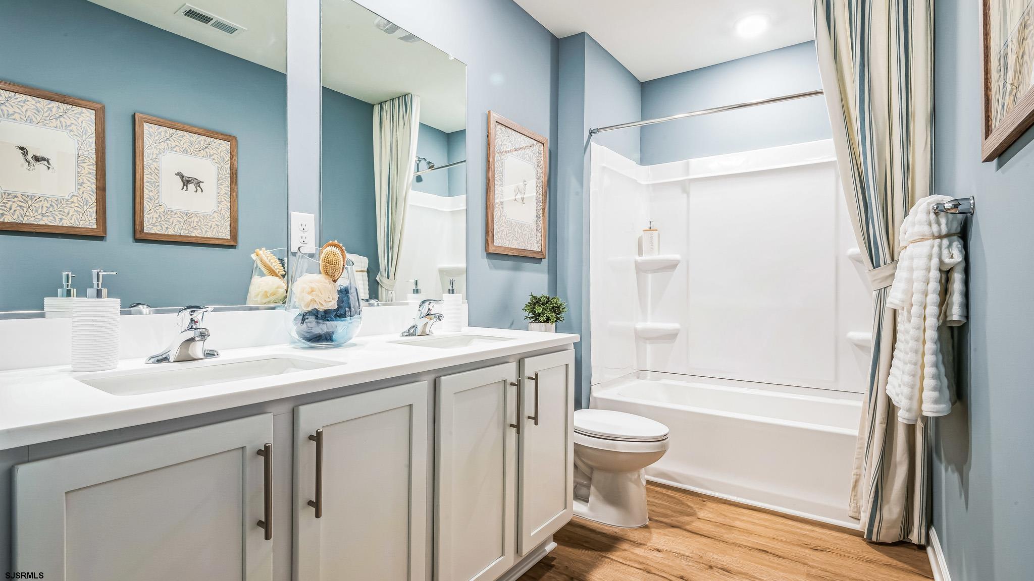 223 Daytona Road Egg Harbor Township, NJ 08234 - Photo 28 of 31 a bathroom with a sink a toilet and a large mirror