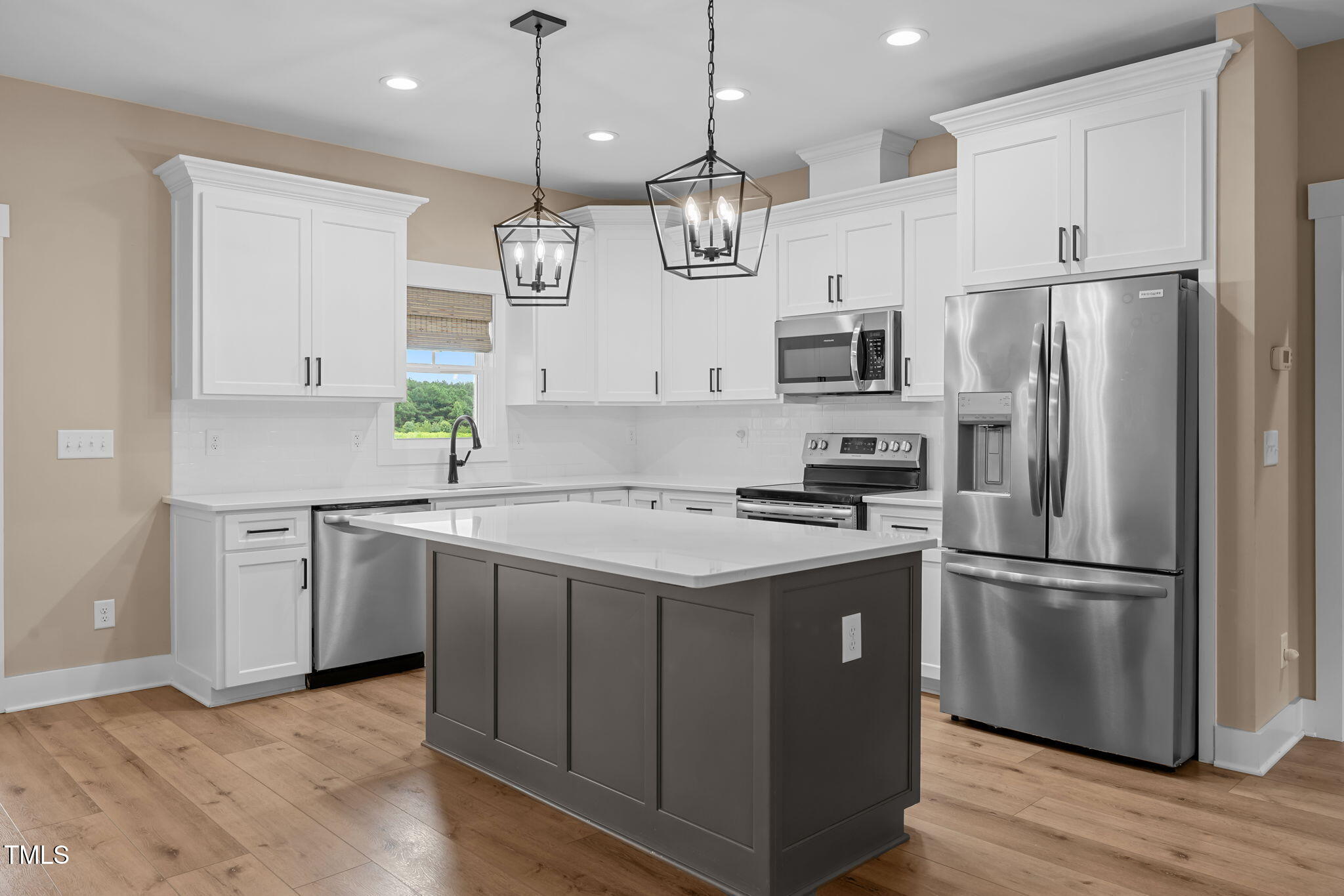 1270 Sheriff Johnson Road Angier, NC 27501 - Photo 6 of 50 a kitchen with kitchen island granite countertop stainless steel appliances a refrigerator a sink and wooden floor