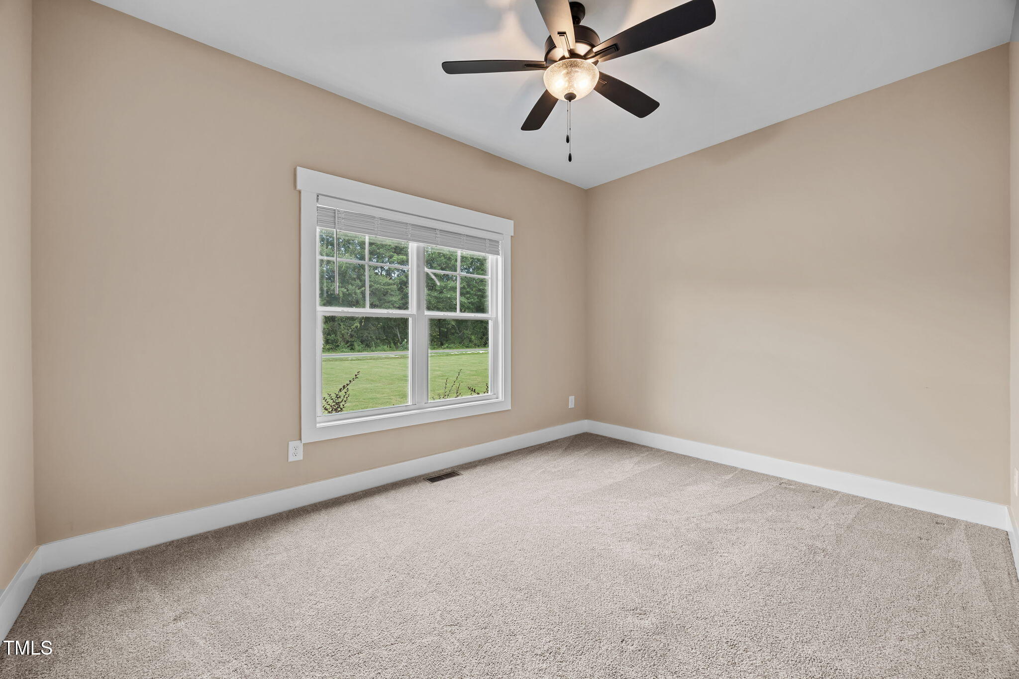 1270 Sheriff Johnson Road Angier, NC 27501 - Photo 19 of 50 an empty room with a window and a fan