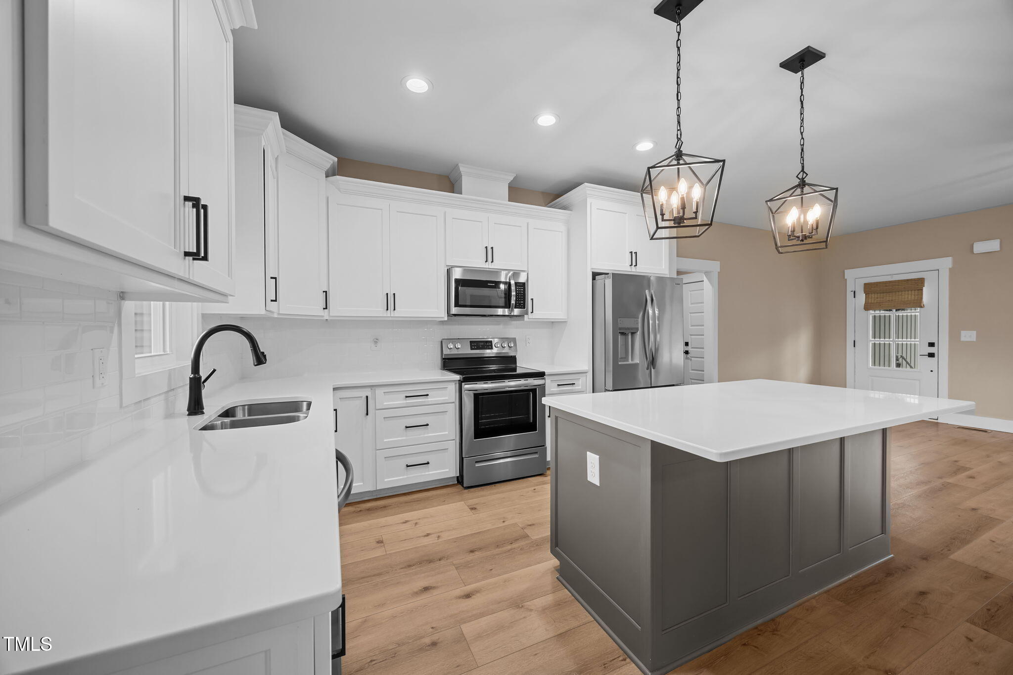 1270 Sheriff Johnson Road Angier, NC 27501 - Photo 3 of 50 a kitchen with stainless steel appliances kitchen island a white cabinets and wooden floor
