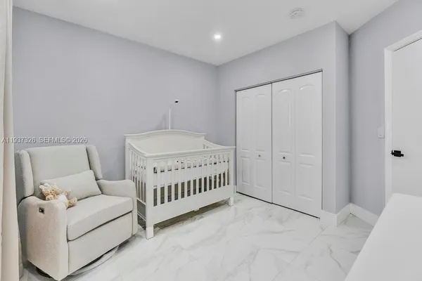 a bedroom with furniture and a ceiling fan
