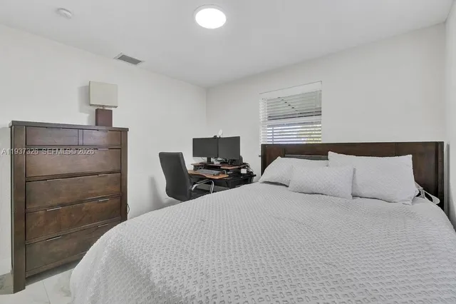 a bedroom with a bed and a television