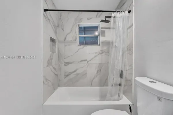 a bathroom with a shower and a toilet