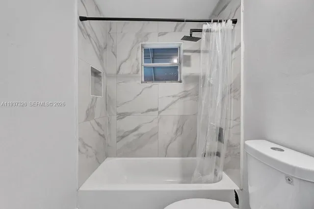 a bathroom with a shower and a toilet