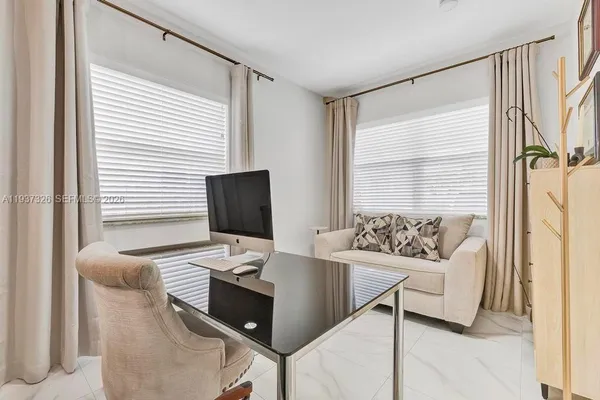 a workspace with furniture and window