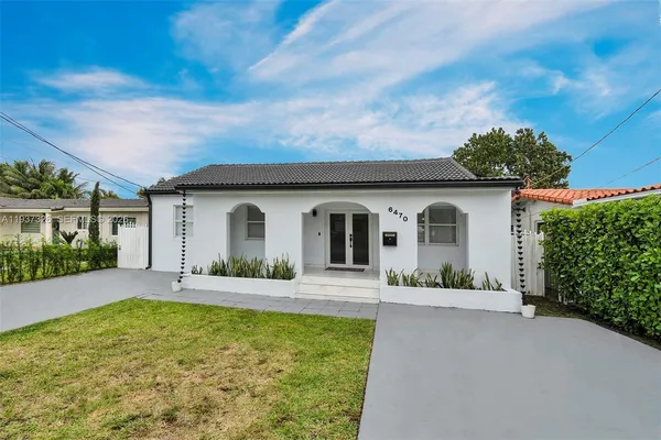 a front view of house with yard and green space
