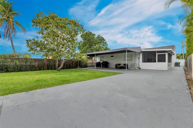 a view of a house with backyard and basketball ground