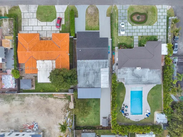 an aerial view of residential houses with outdoor space