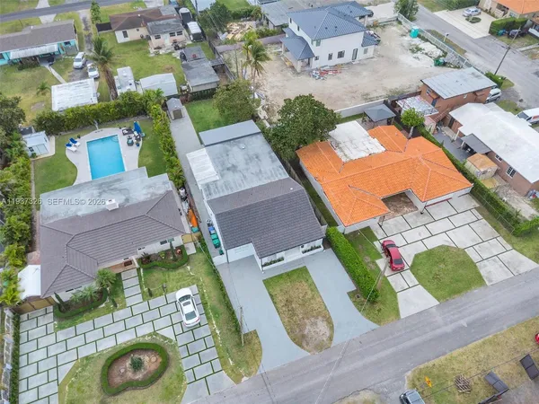 an aerial view of residential houses with outdoor space