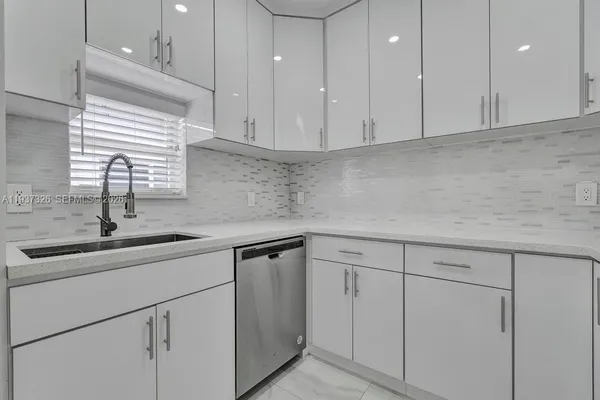 a kitchen with a sink and cabinets
