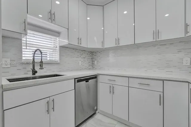 a kitchen with a sink and cabinets