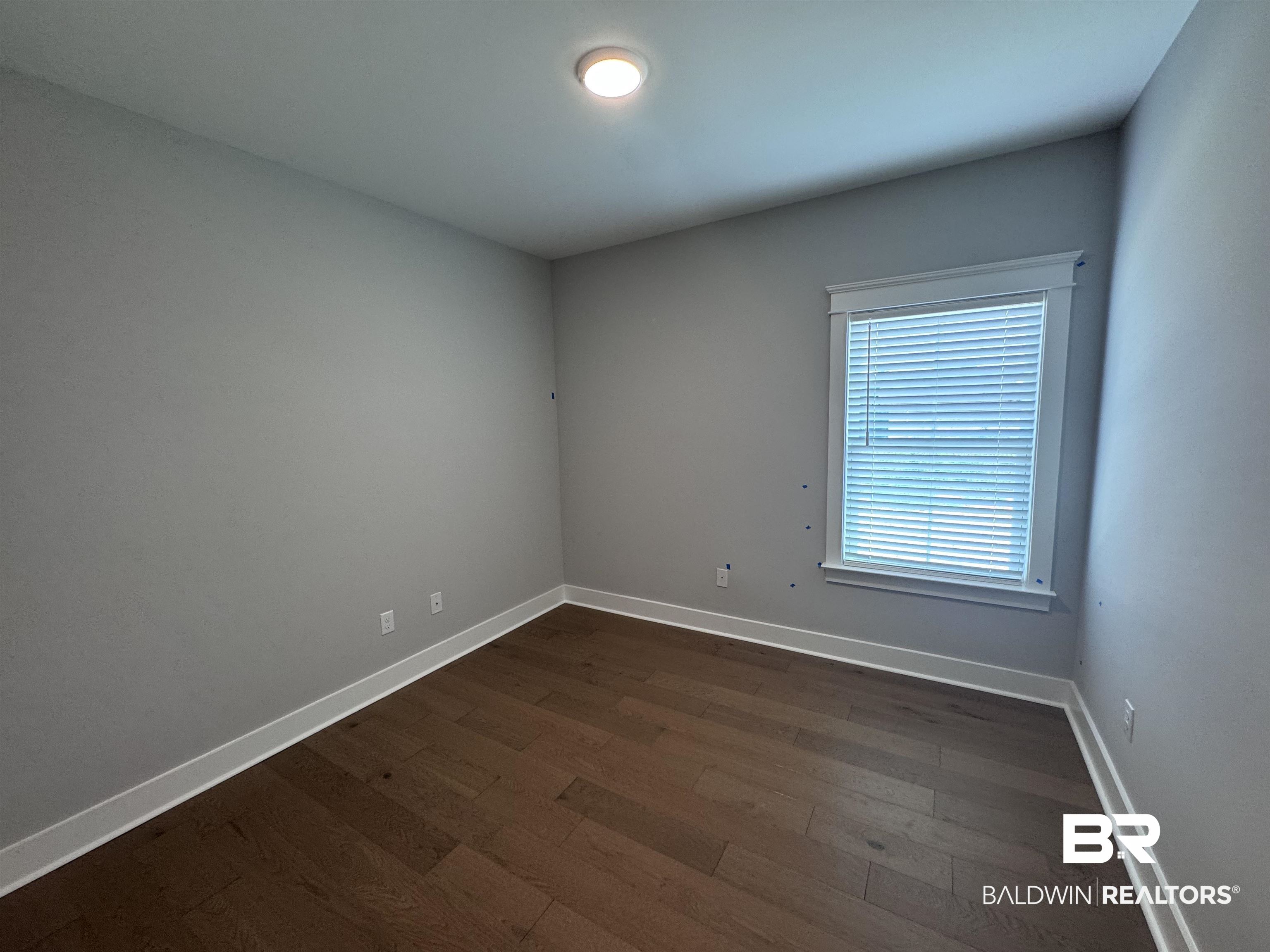 27371 Patch Pl Loop Daphne, AL 36526 - Photo 49 of 63 Empty room with dark wood-style flooring and baseboards