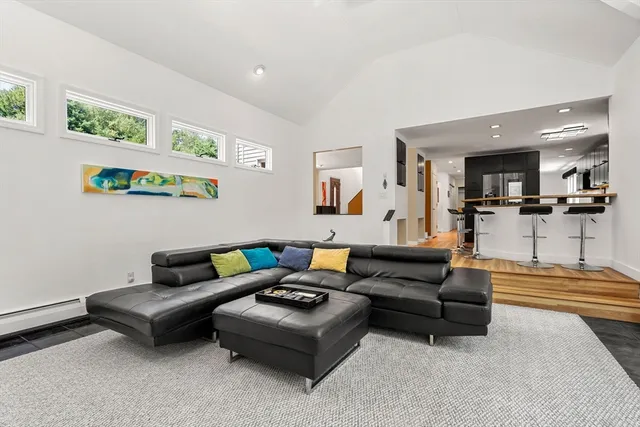 a living room with furniture and kitchen view