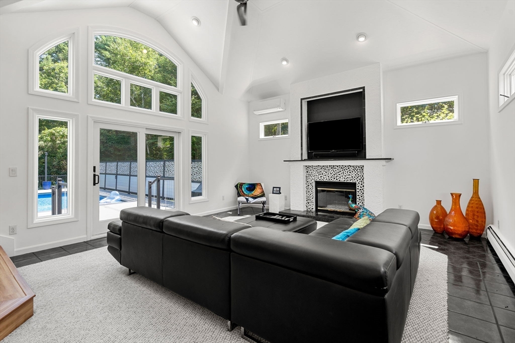 49 Parker Road Shirley, MA 01464 - Photo 13 of 42 a living room with fireplace furniture and a flat screen tv