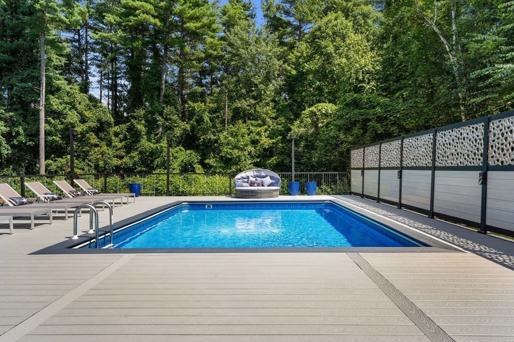 49 Parker Road Shirley, MA 01464 - Photo 15 of 42 a view of a swimming pool with a chair and tables