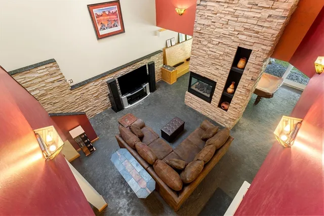 a living room with furniture and a fireplace