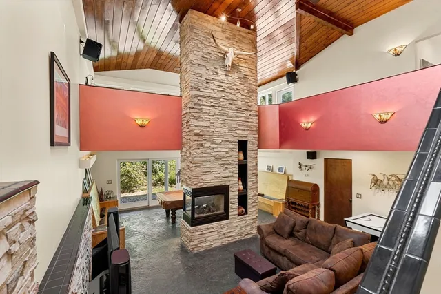 a room with pool table and windows